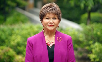 A woman wearing a pink blazer